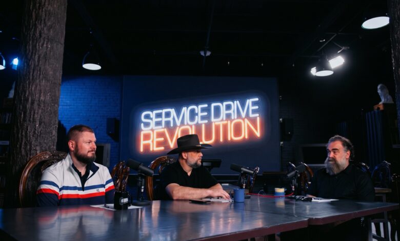 Service manager holding a focused one-on-one coaching meeting with a service advisor
